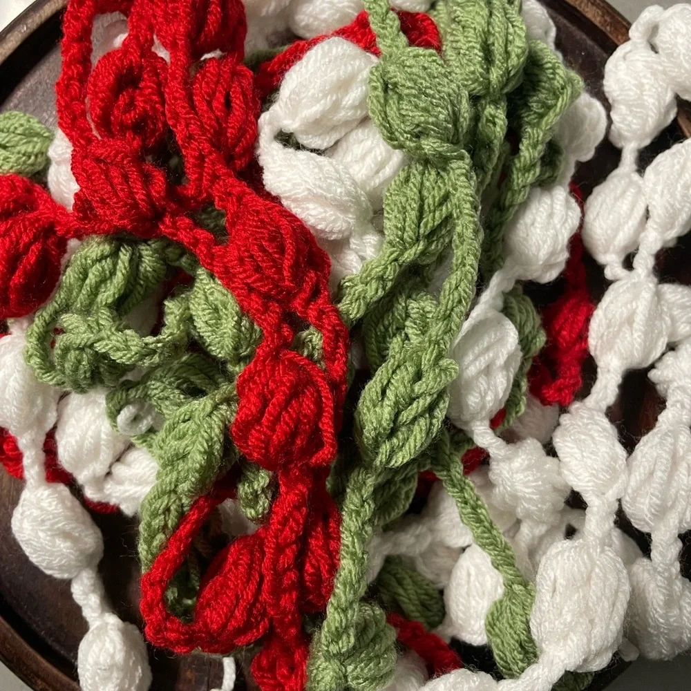 3 separate strands green, red and off white of homemade crocheted garland 9 ft
